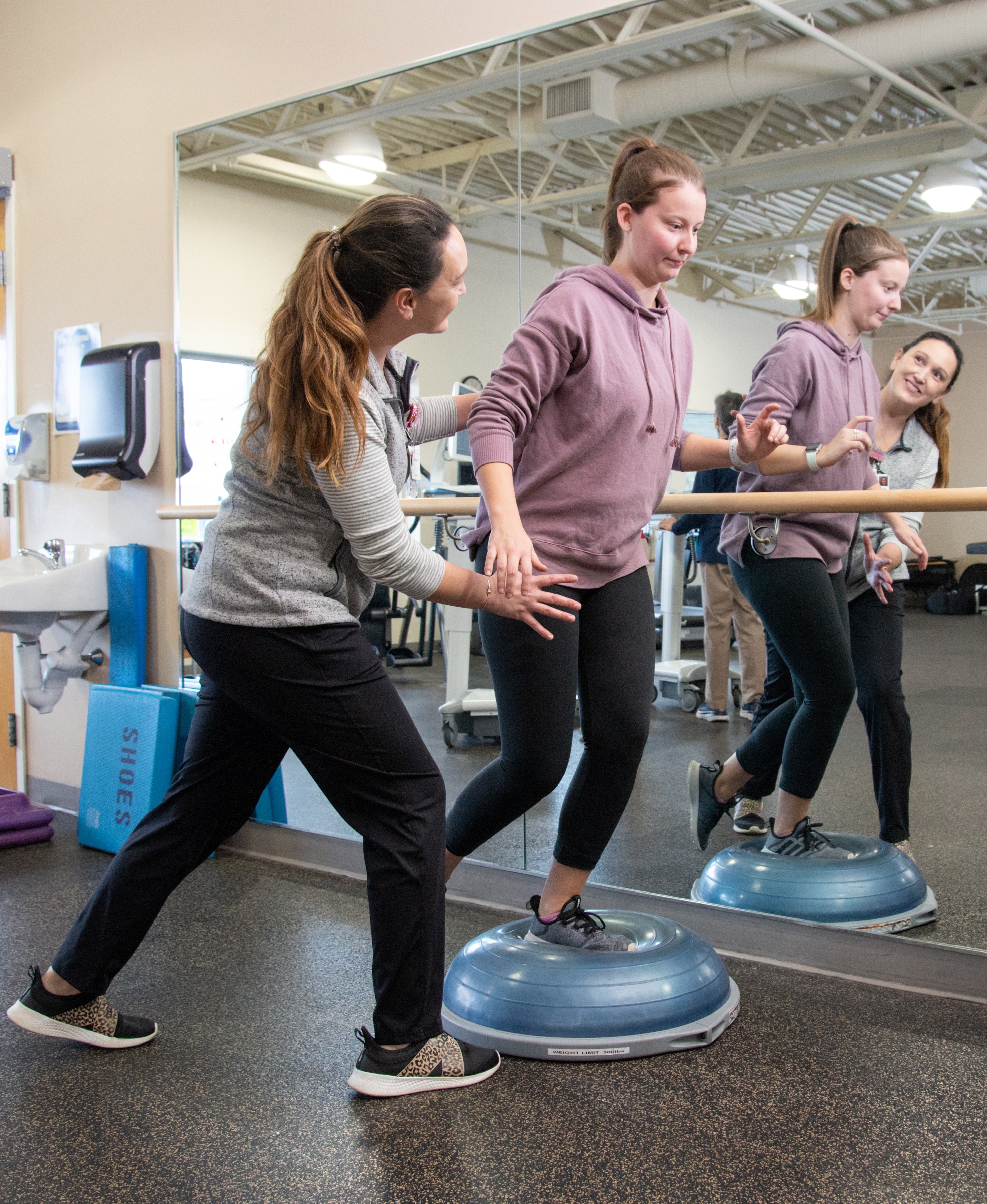 Manager of Rehab and sports medicine facility working with a patient on Cybex machine