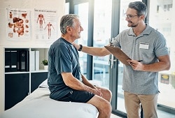 patient and physical therapist talking