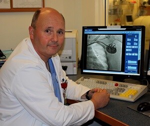 Dr. William Shine, cardiologist viewing the pacemaker implanted in his patient