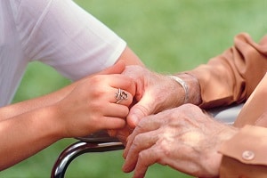 Nurse and patient holding hands