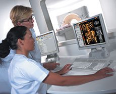 Two technicians viewing ct scan image